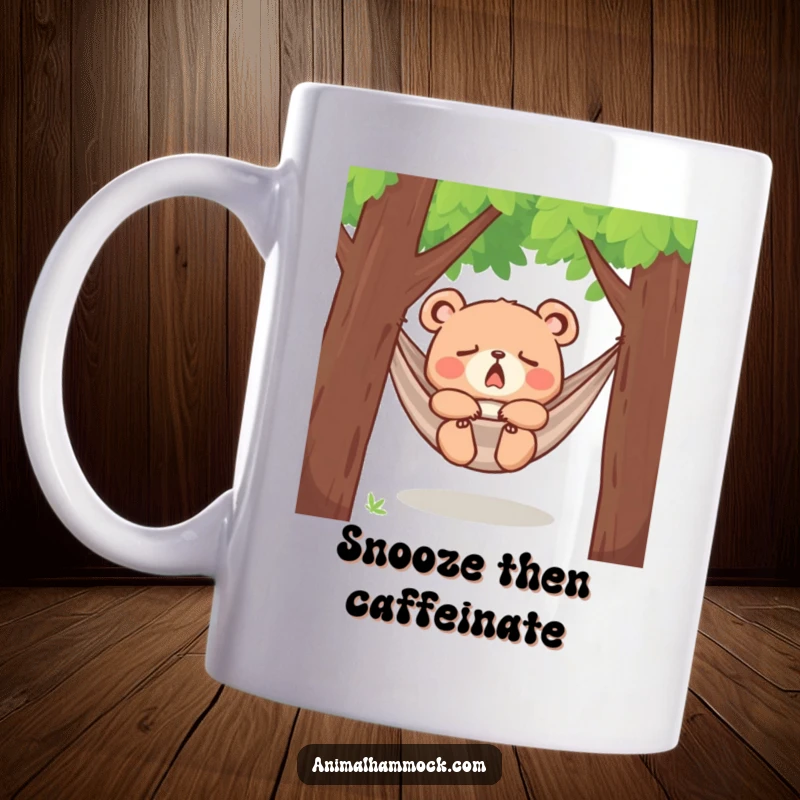 Funny yawning bear cub dozing peacefully in a hammock between trees, printed on a mug, capturing adorable sleepiness and relaxation.