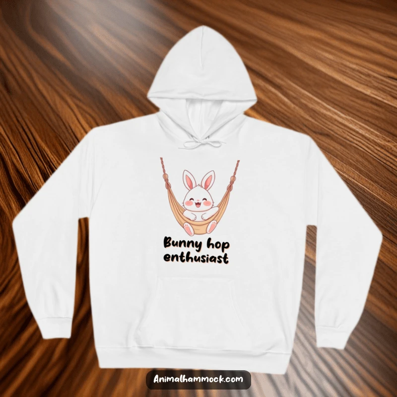 Funny fluffy bunny with rosy cheeks bouncing excitedly in a hammock, featured on this warm and cozy hoodie.