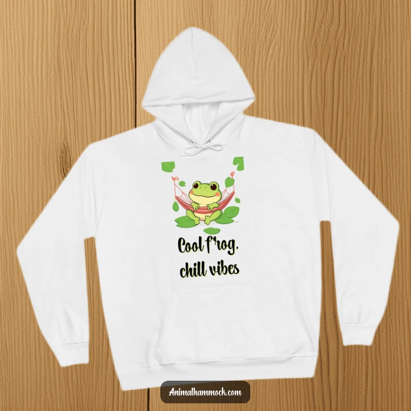 Funny green frog with a wide grin relaxing in a hammock on a soft hoodie, perfect for chill vibes.