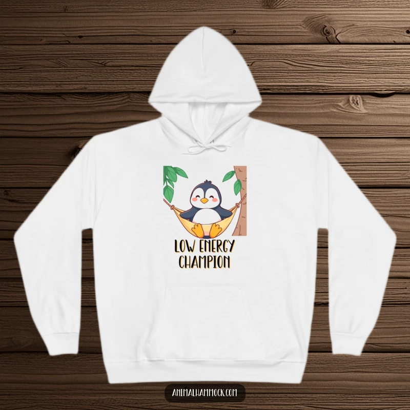 Funny hoodie depicting a proud penguin character sitting upright, smiling blissfully while lounging in a comfortable hammock.