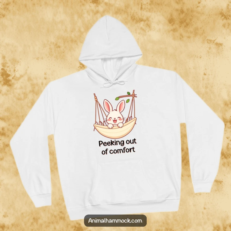 Funny rabbit hoodie showing a joyful rabbit peeking over the edge of a hammock, blending cozy warmth with relaxed vibes.