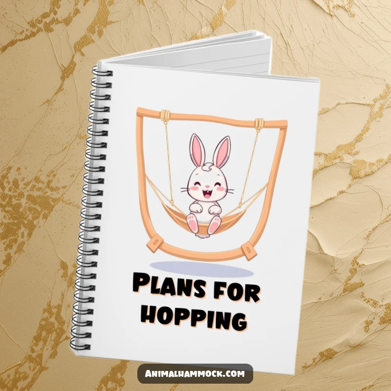 Funny cheerful bunny bouncing in a hammock, featured on a notebook cover for humorous note-taking and cheerful journaling.