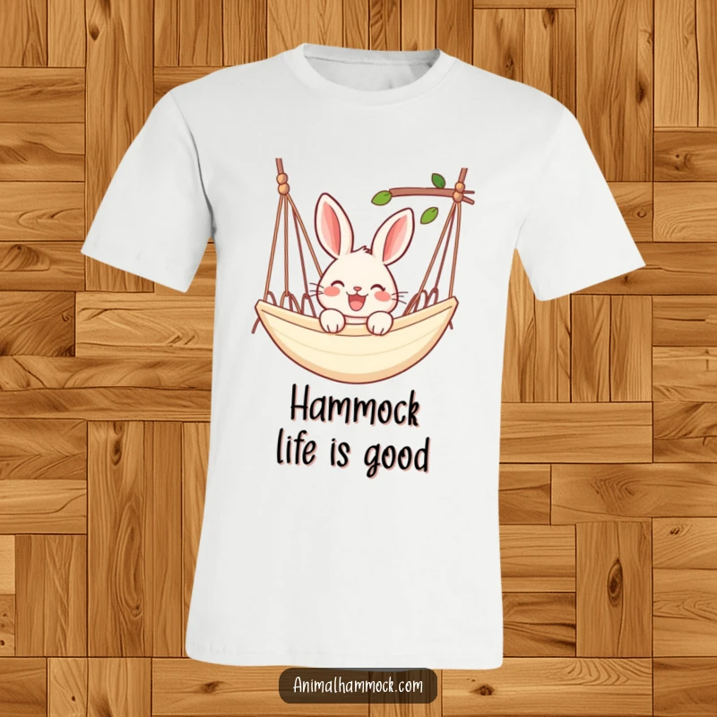 Funny rabbit t-shirt depicting a joyful rabbit peeking over the edge of a hammock, celebrating laid-back fun.