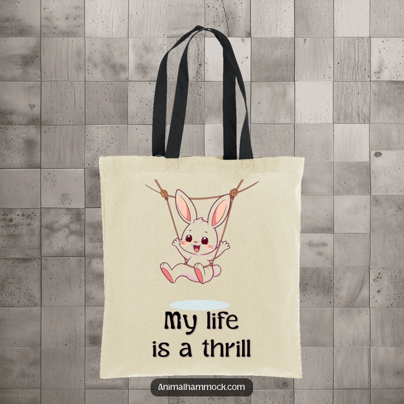 Funny tote bag featuring a lively bunny character dangling from a hammock, kicking its legs with unrestrained joy and playful abandon.